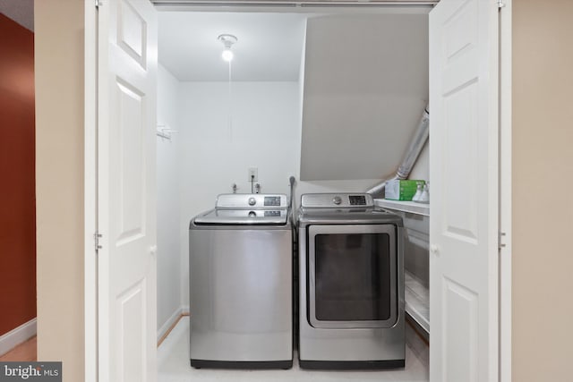 washroom with washing machine and clothes dryer