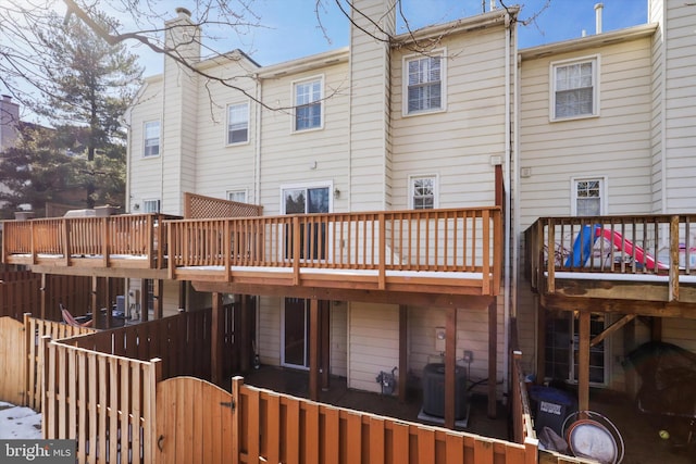 rear view of property with a deck and central air condition unit