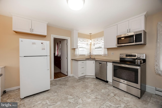 kitchen with stainless steel appliances, white cabinetry, and sink