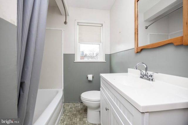 full bathroom with vanity, shower / bath combo, and toilet