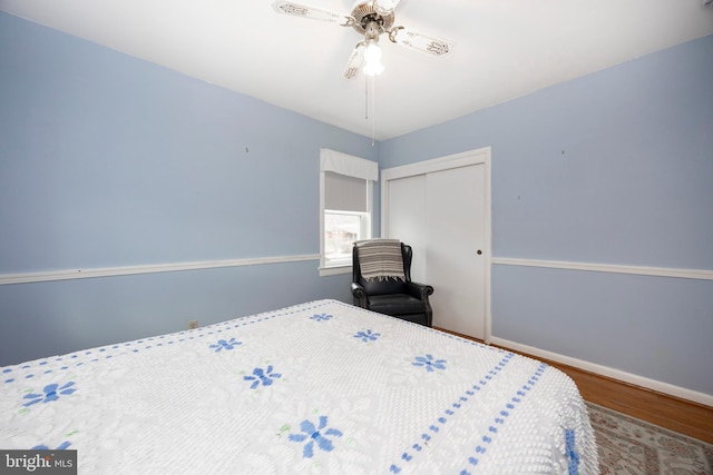 bedroom with hardwood / wood-style flooring, a closet, and ceiling fan