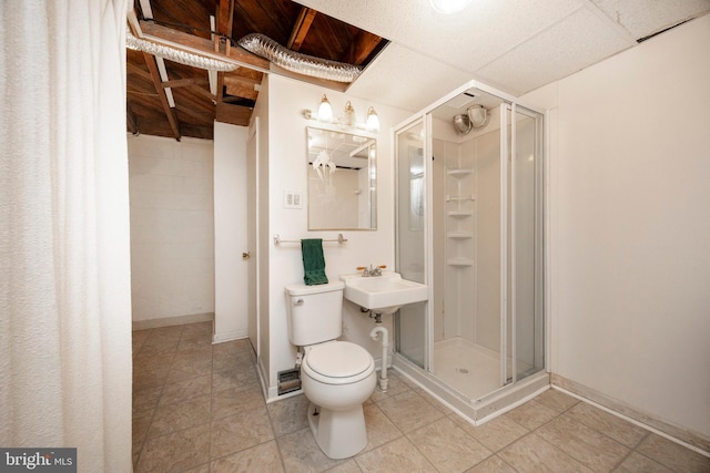 bathroom featuring sink, tile patterned floors, toilet, and a shower with door