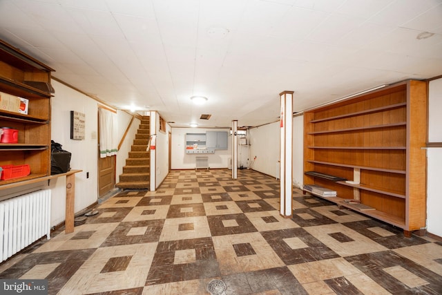 basement featuring radiator and built in shelves