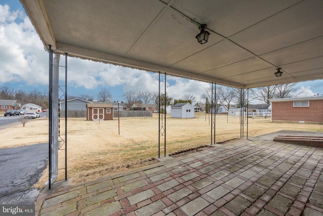 view of patio / terrace featuring a storage unit