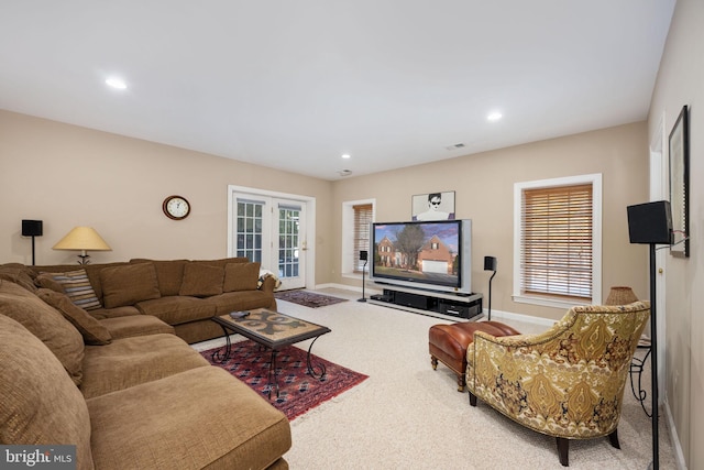 living room featuring french doors, a healthy amount of sunlight, and carpet