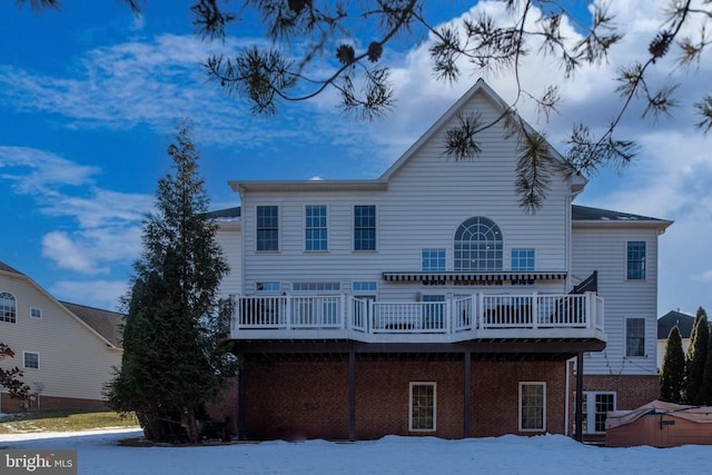 snow covered property featuring a deck