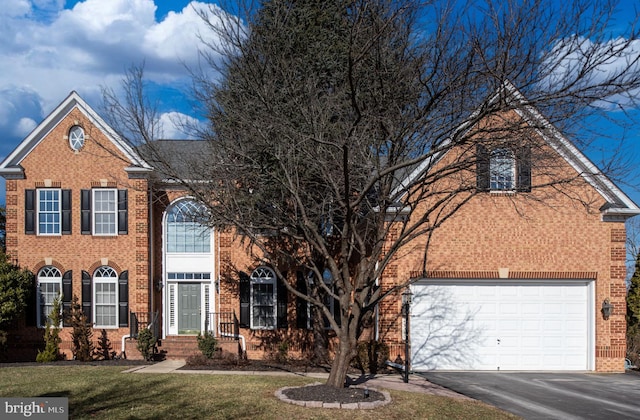 front of property with a garage and a front yard