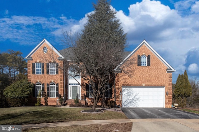 view of property featuring a garage and a front yard