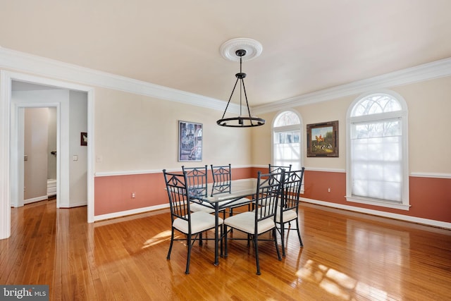 dining area featuring ornamental molding and hardwood / wood-style floors