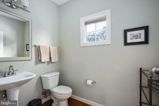 bathroom with sink, toilet, and hardwood / wood-style floors