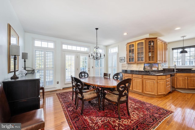 dining space with a chandelier and light hardwood / wood-style floors