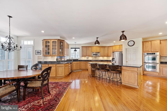 interior space featuring sink, an inviting chandelier, and light hardwood / wood-style flooring