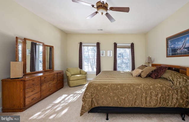 bedroom featuring light carpet and ceiling fan