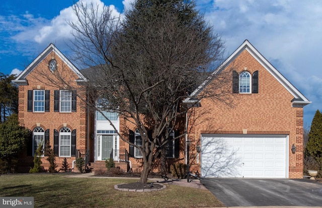 front facade with a garage and a front yard