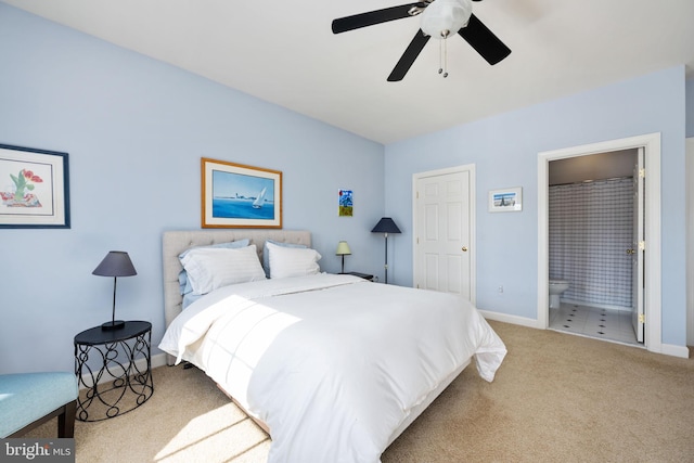 carpeted bedroom with connected bathroom and ceiling fan