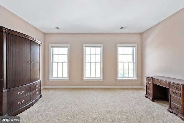 carpeted bedroom with multiple windows