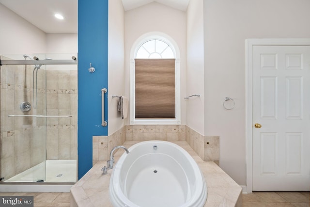 bathroom with lofted ceiling, sink, tile patterned floors, and separate shower and tub