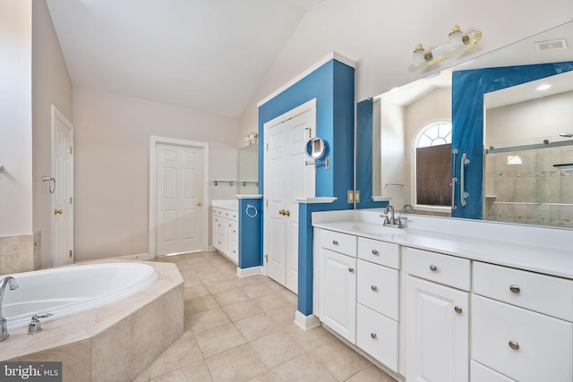 bathroom with tile patterned flooring, vanity, lofted ceiling, and separate shower and tub