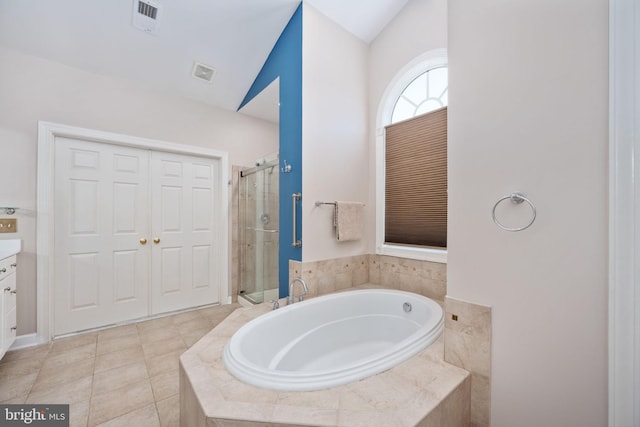 bathroom featuring vanity, tile patterned flooring, vaulted ceiling, and separate shower and tub