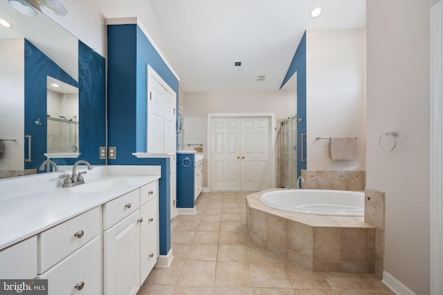 bathroom featuring tile patterned flooring, vanity, and independent shower and bath