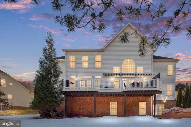 view of front of home with a wooden deck and a hot tub