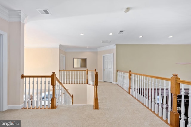 hallway featuring ornamental molding and light carpet