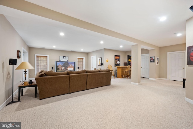 living room featuring indoor bar and light colored carpet