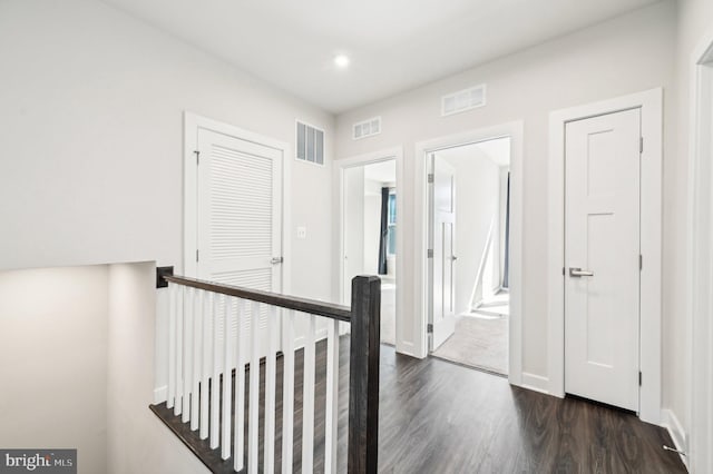 corridor with dark hardwood / wood-style floors