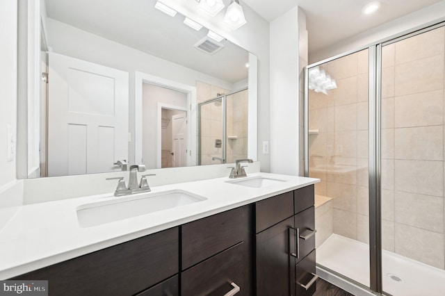 bathroom featuring vanity and an enclosed shower