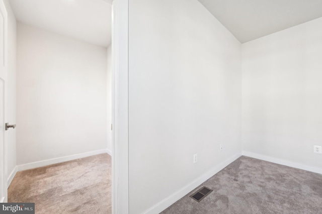 empty room featuring light colored carpet