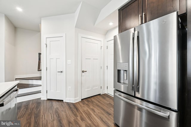 kitchen with dark wood-type flooring, dark brown cabinets, and appliances with stainless steel finishes