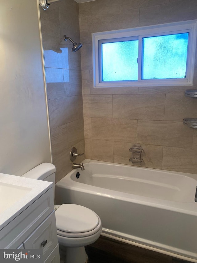 full bathroom with vanity, toilet, and tiled shower / bath combo