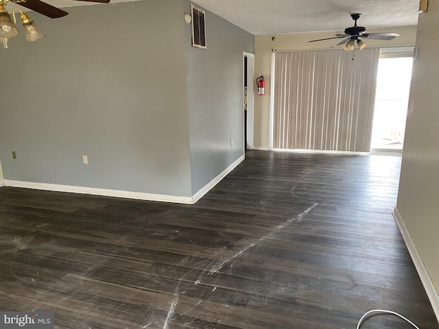 empty room with dark hardwood / wood-style floors and ceiling fan