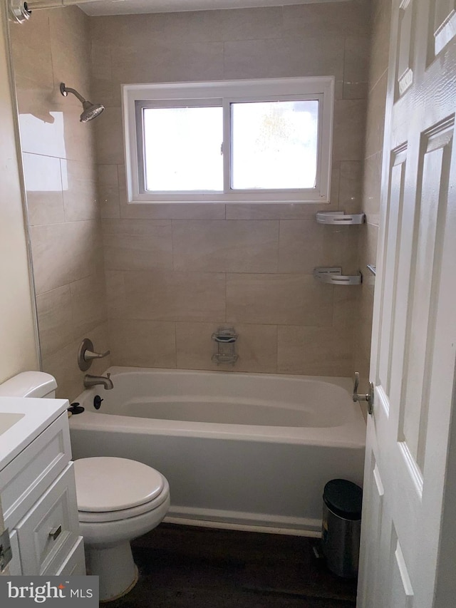 full bathroom with tiled shower / bath combo, vanity, a wealth of natural light, and toilet