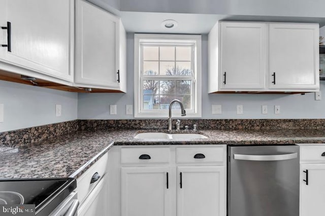 kitchen with white cabinetry, sink, stainless steel dishwasher, and dark stone counters