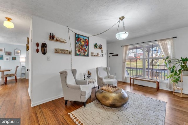 sitting room featuring hardwood / wood-style floors and a textured ceiling