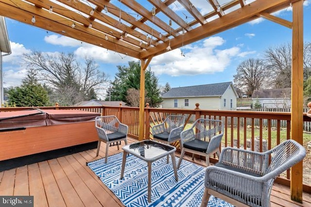 wooden terrace featuring a hot tub and a pergola