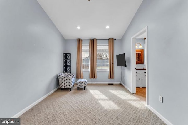 unfurnished room with light colored carpet and lofted ceiling