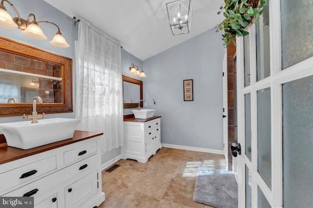 bathroom with vanity and vaulted ceiling