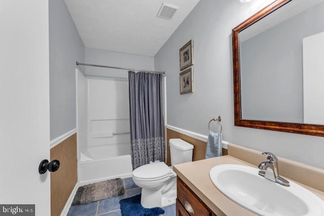 full bathroom with shower / tub combo with curtain, vanity, toilet, and tile patterned floors