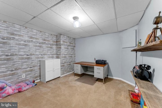 carpeted office space with a drop ceiling