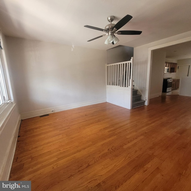 unfurnished living room with ceiling fan and hardwood / wood-style floors