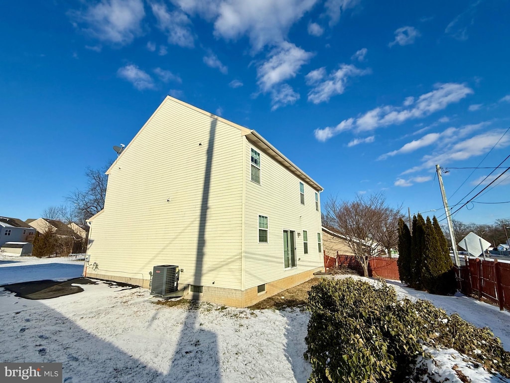 view of snow covered exterior featuring cooling unit