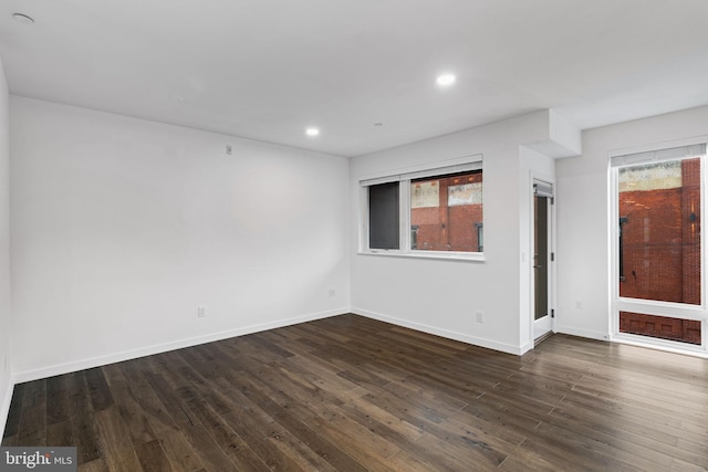 spare room featuring dark hardwood / wood-style floors