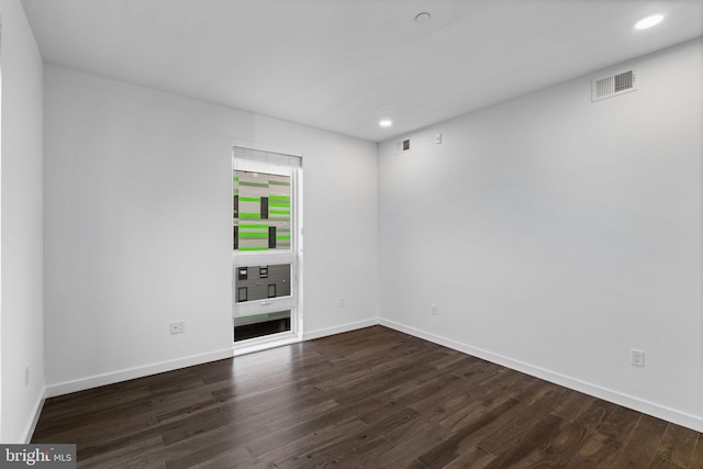 empty room with dark hardwood / wood-style floors