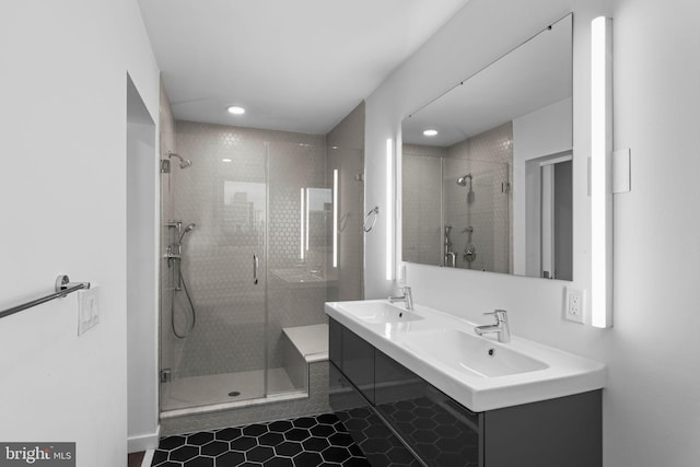 bathroom featuring vanity, a shower with shower door, and tile patterned floors