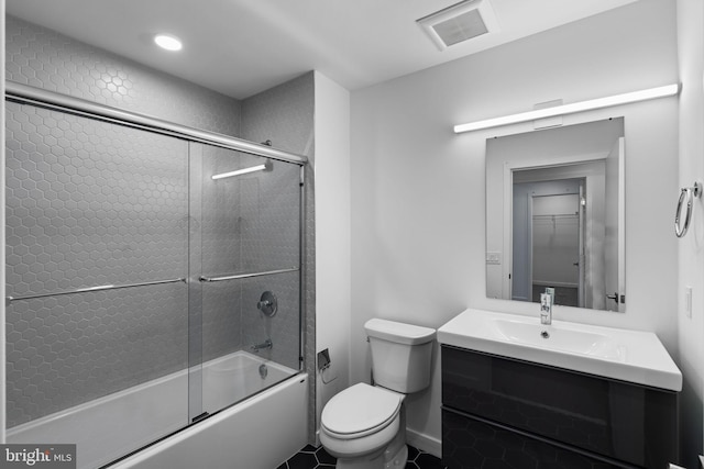 full bathroom with tile patterned floors, vanity, toilet, and combined bath / shower with glass door