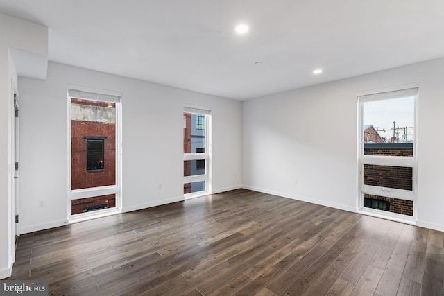 unfurnished living room with dark hardwood / wood-style floors