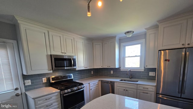 kitchen with white cabinetry, appliances with stainless steel finishes, and sink