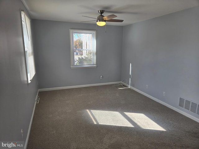 carpeted spare room featuring ceiling fan